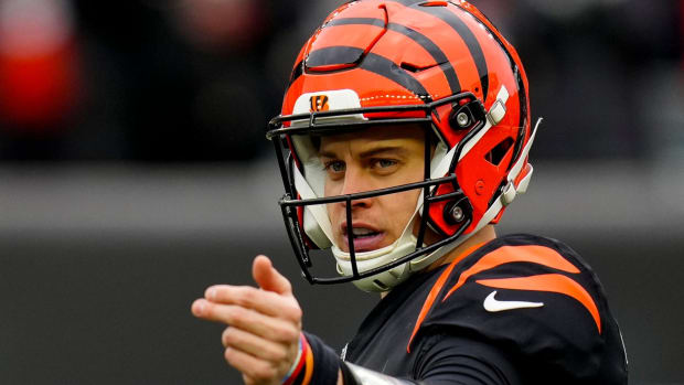 Cincinnati Bengals quarterback Joe Burrow (9) adjusts wide receiver Ja'Marr Chase (1) on the line before a play in the second quarter of the NFL Week 14 game between the Cincinnati Bengals and the Cleveland Browns at Paycor Stadium in Cincinnati on Sunday, Dec. 11, 2022. The Bengals led 13-3 at halftime. Cleveland Browns At Cincinnati Bengals Week 14